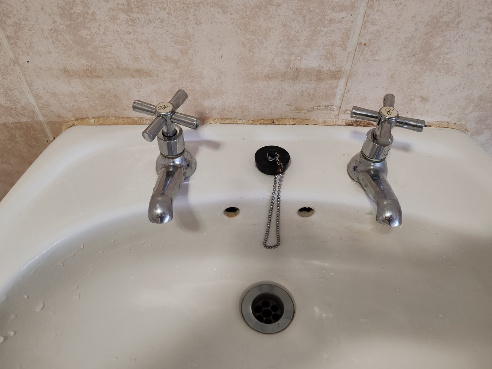 Bathroom basin taps and drain area for plumbing service