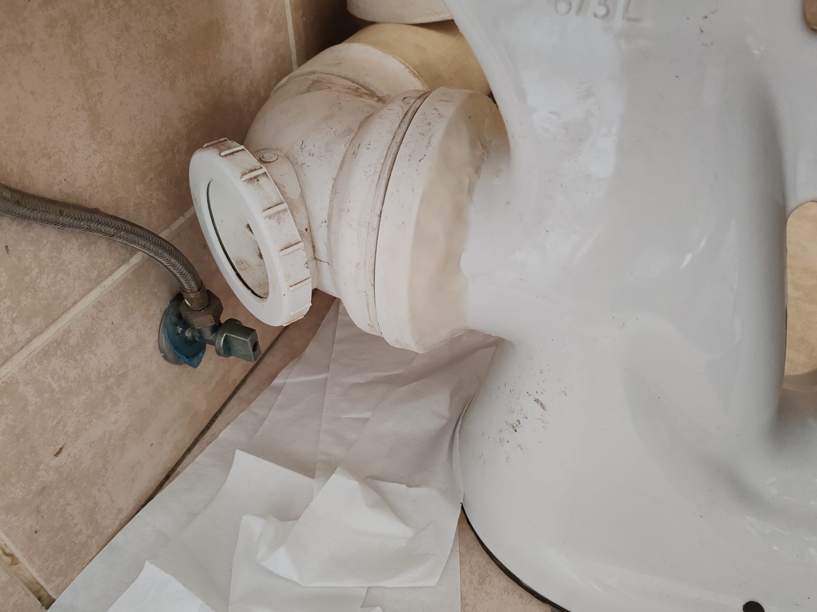Bathroom plumbing repair at toilet outlet and water feed